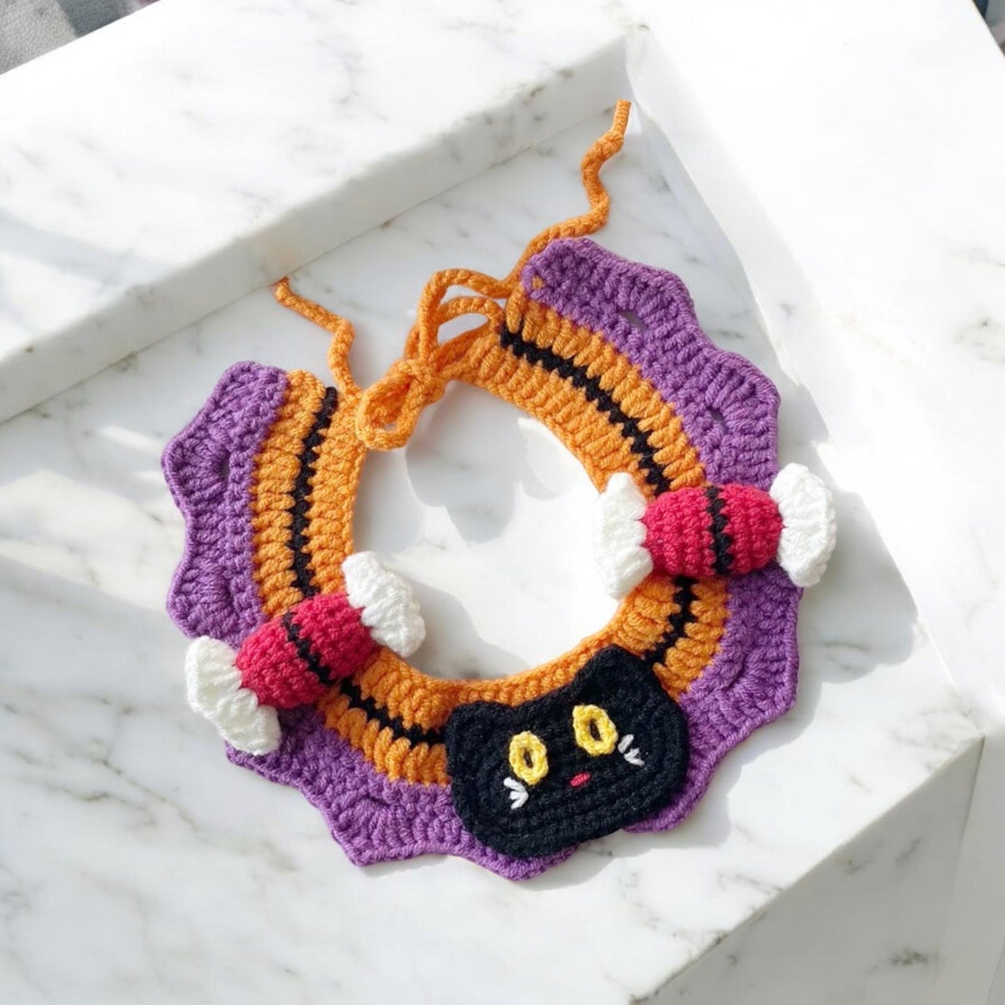 A handcrafted pet collar, with Halloween elements like black cat, trick or treat candies