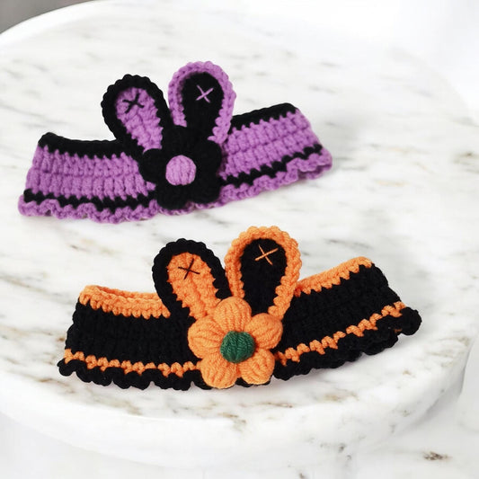 Crocheted pet collar featuring patterns in purple and orange colors with decorative flower and bunny ears in the center.